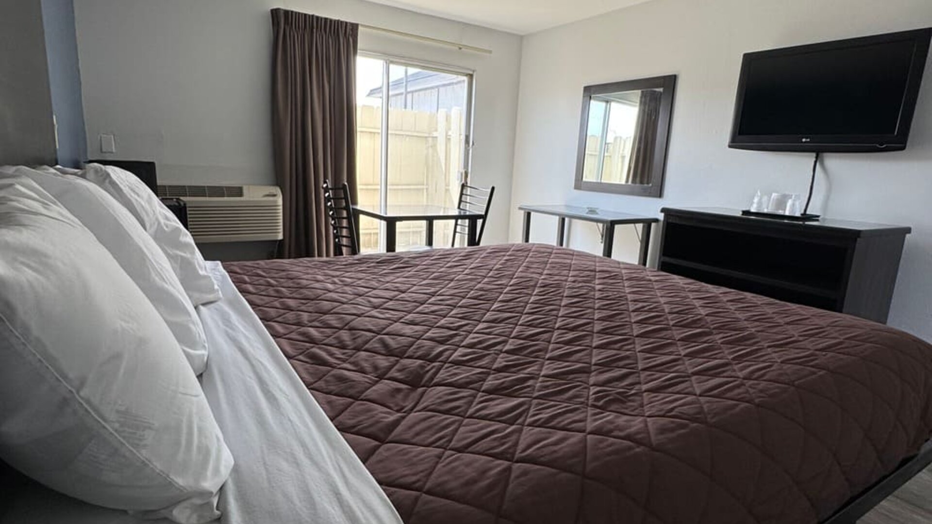 Day room with natural light and king bed at Economy Inn.