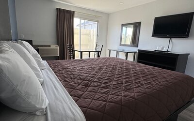 Day room with natural light and king bed at Economy Inn.