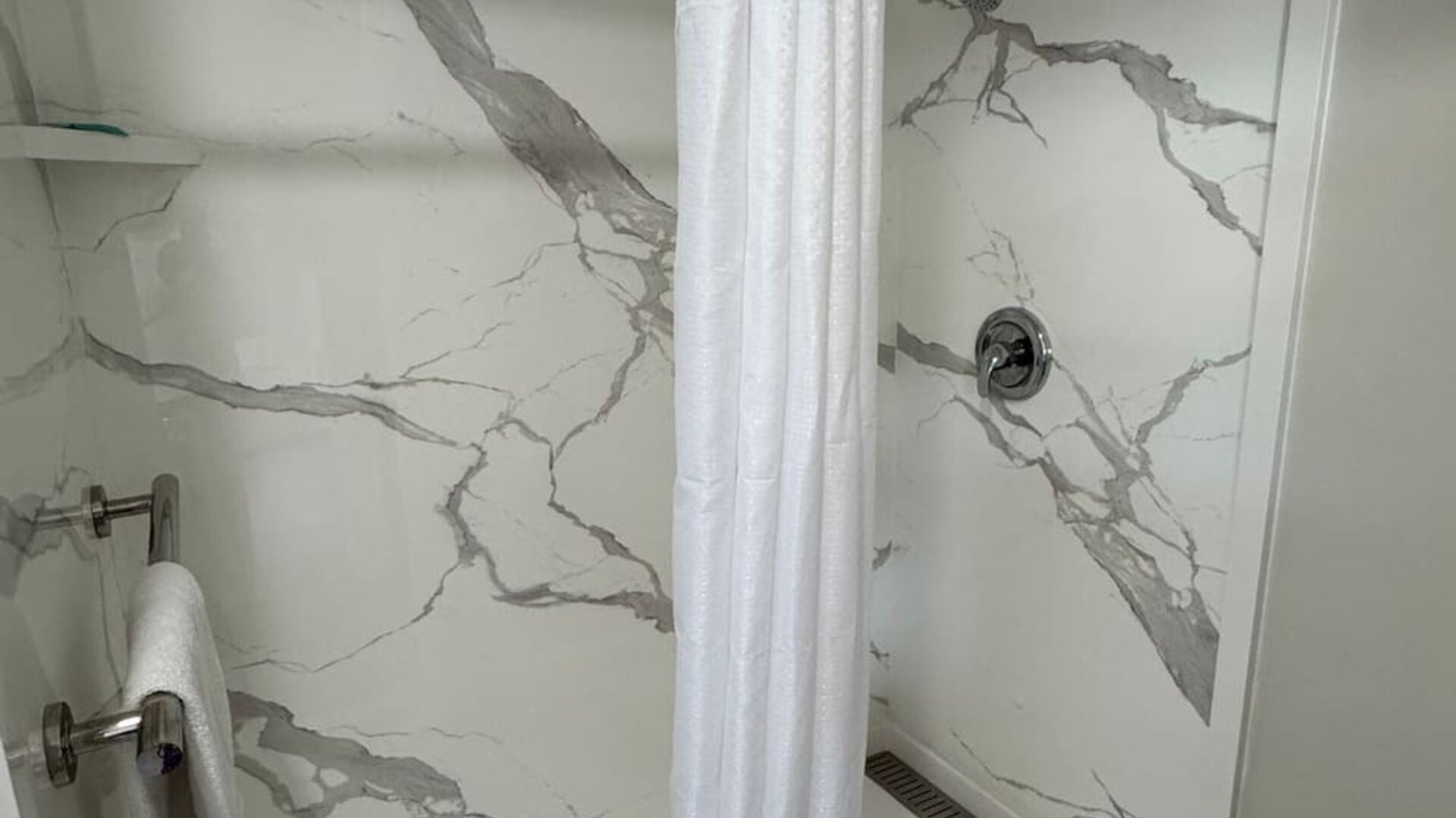 Guest bathroom with shower and toilet at Economy Inn.