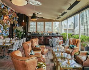 Lounge area with comfortable seating and bar setup at Le Méridien New York, Central Park.