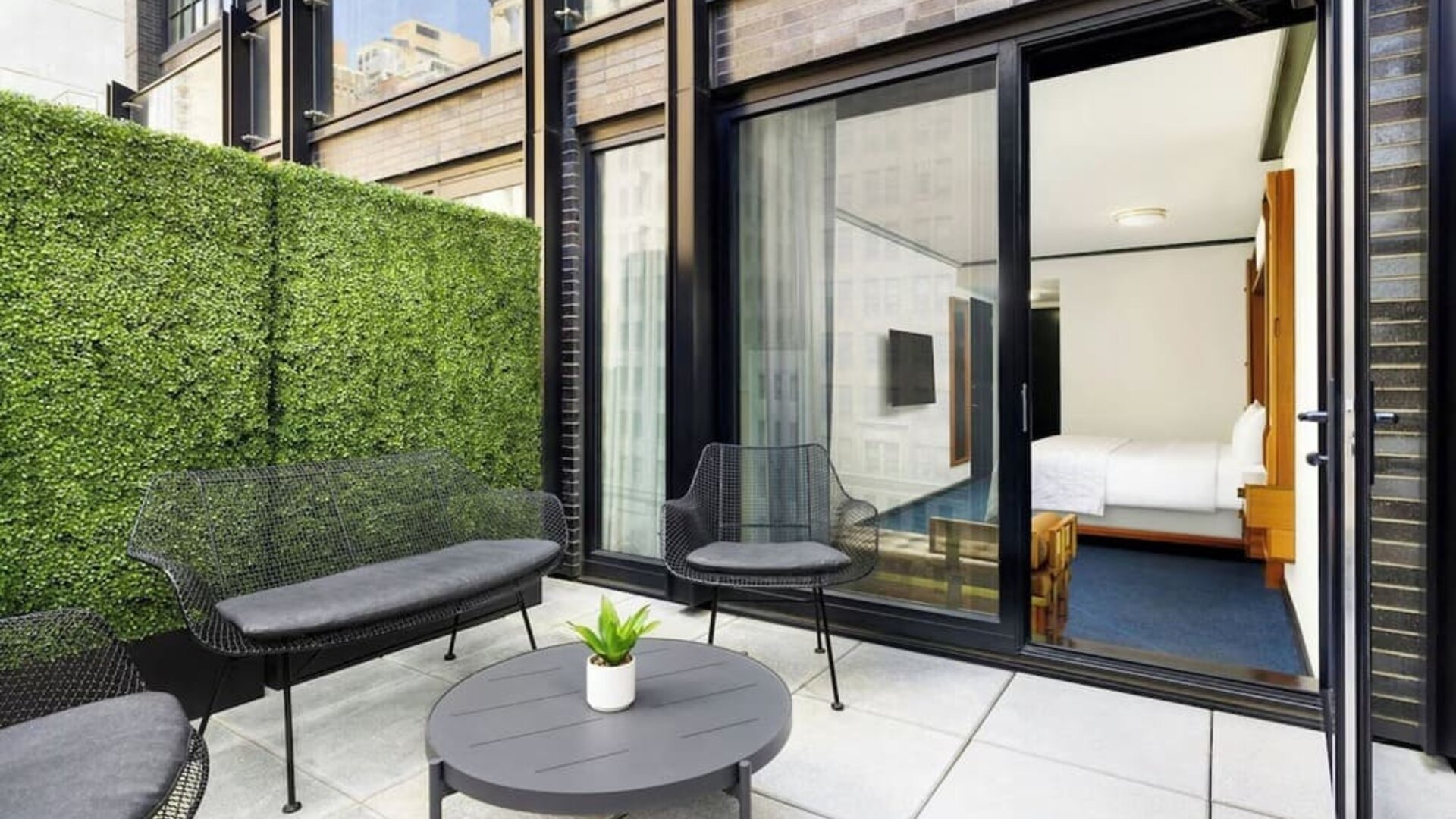 Private balcony with outdoor seating and access to guest room at Le Méridien New York, Central Park.