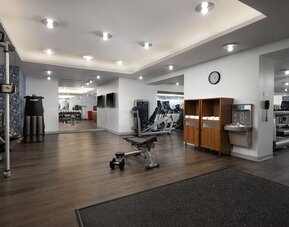 Fitness center with cardio machines, weights, and workout equipment at Le Méridien New York, Central Park.