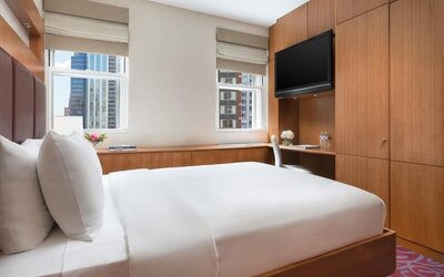 Guest room with king bed, workspace, and city views at Hotel 57.