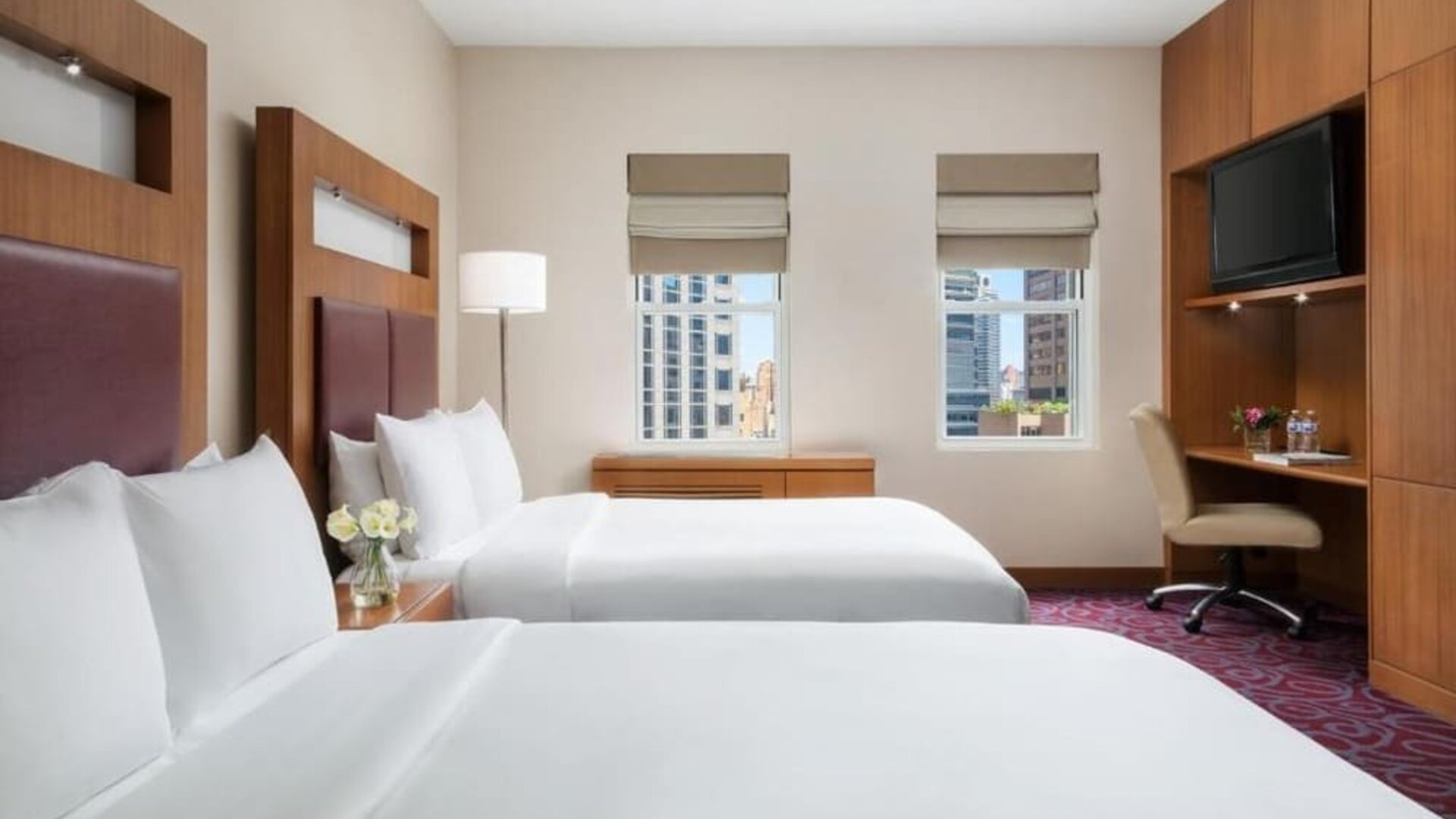 Guest room with two beds and workspace at Hotel 57.