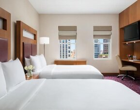Guest room with two beds and workspace at Hotel 57.