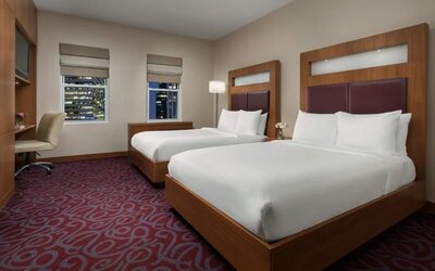 Guest room with two beds and workspace at Hotel 57.