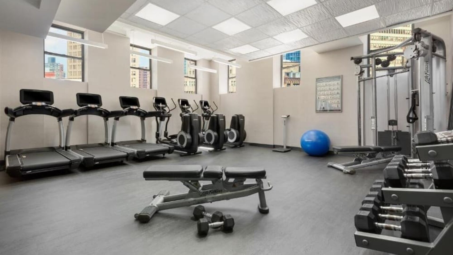 Fitness center with treadmills, weights, and strength equipment at Hotel 57.
