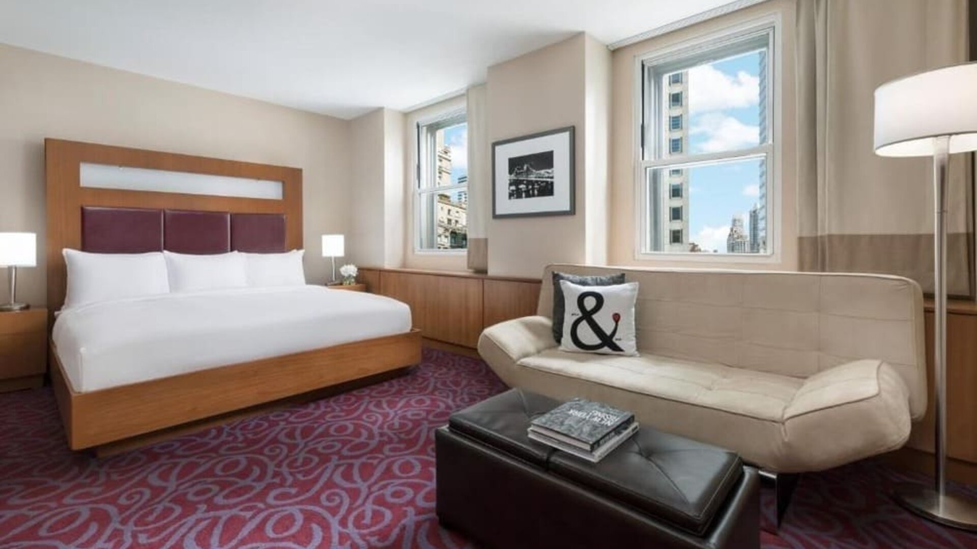 Guest room with sofa seating and natural light at Hotel 57.