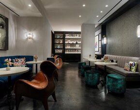 Lounge area with seating, tables, and reading space at Hotel 57.