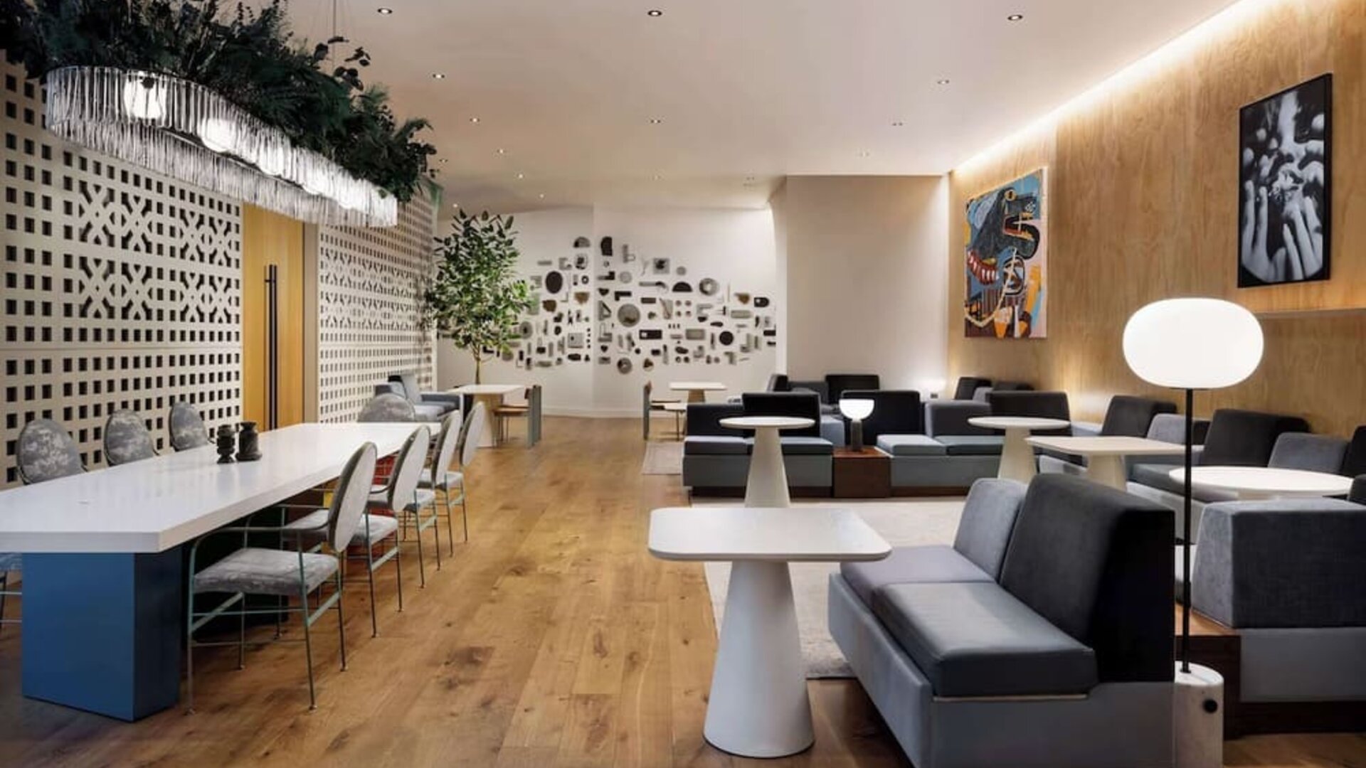 Stylish lounge area with modern seating, soft lighting, and decorative wall features at Timbri Hotel San Francisco, Curio Collection By Hilton.