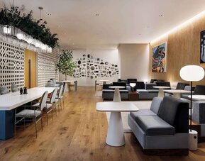 Stylish lounge area with modern seating, soft lighting, and decorative wall features at Timbri Hotel San Francisco, Curio Collection By Hilton.