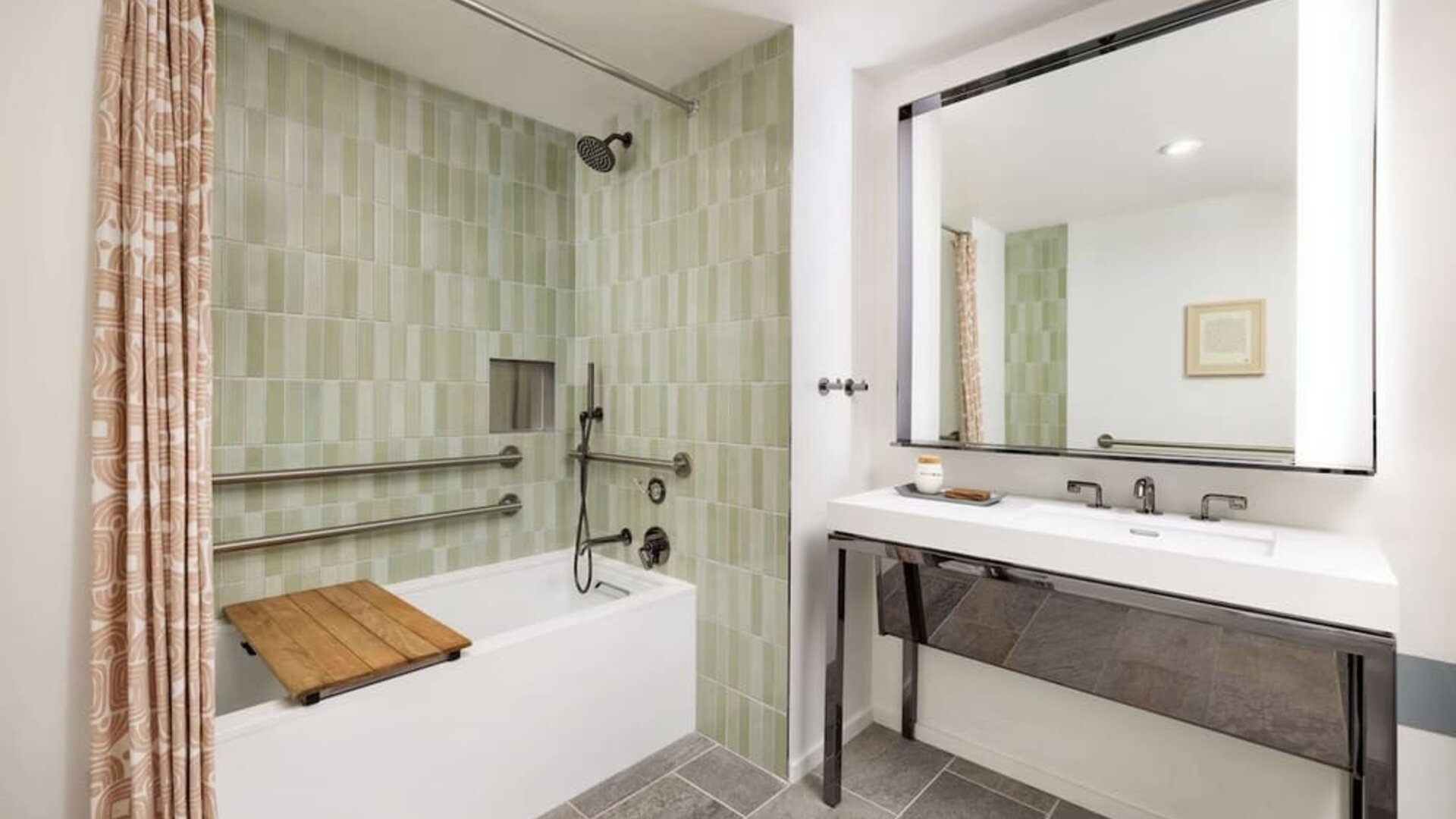 Accessible bathroom with bathtub, grab rails, handheld shower, and modern vanity at Timbri Hotel San Francisco, Curio Collection By Hilton.