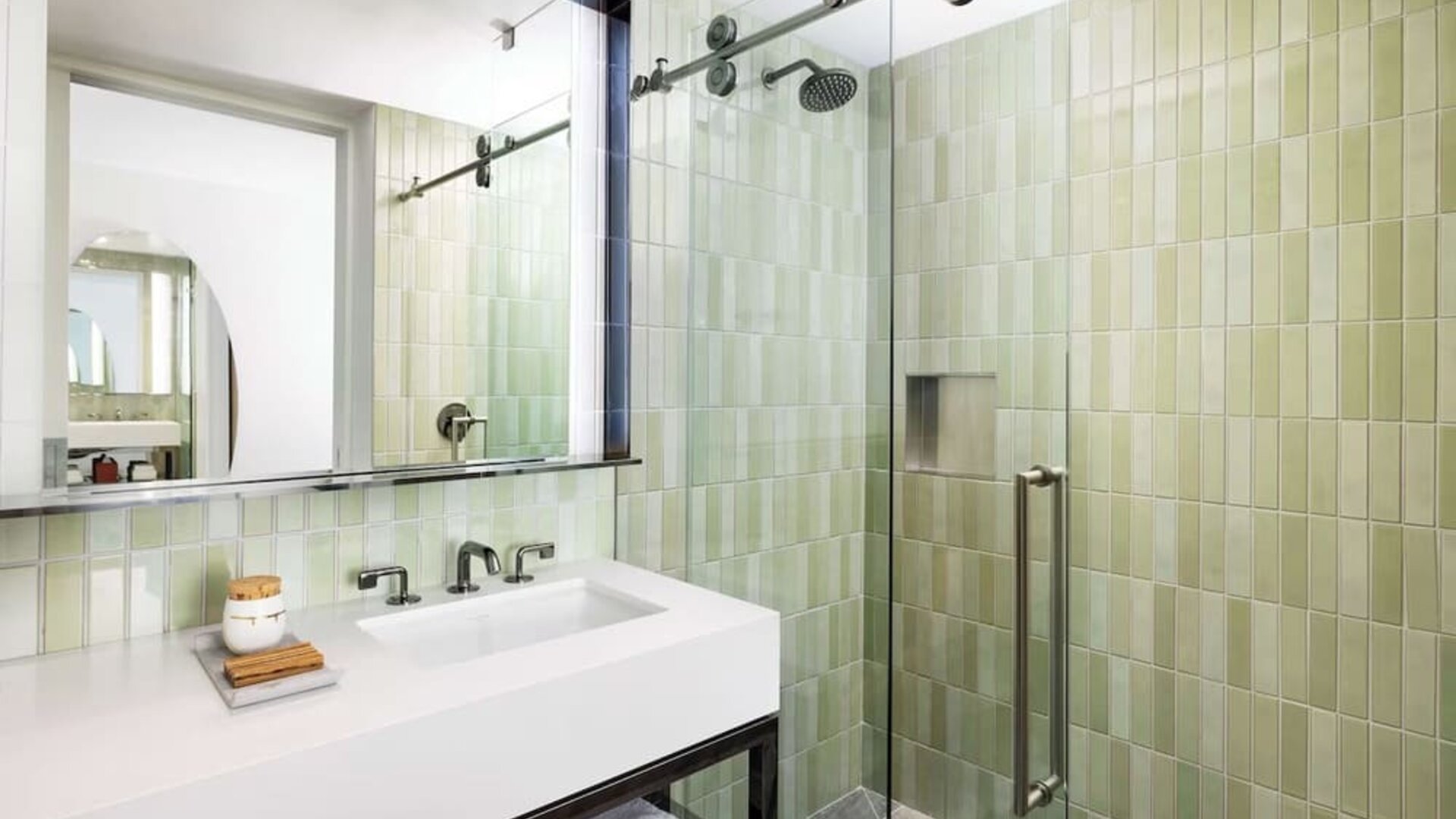 Modern bathroom with glass walk-in shower, green tile finish, and sleek vanity at Timbri Hotel San Francisco, Curio Collection By Hilton.