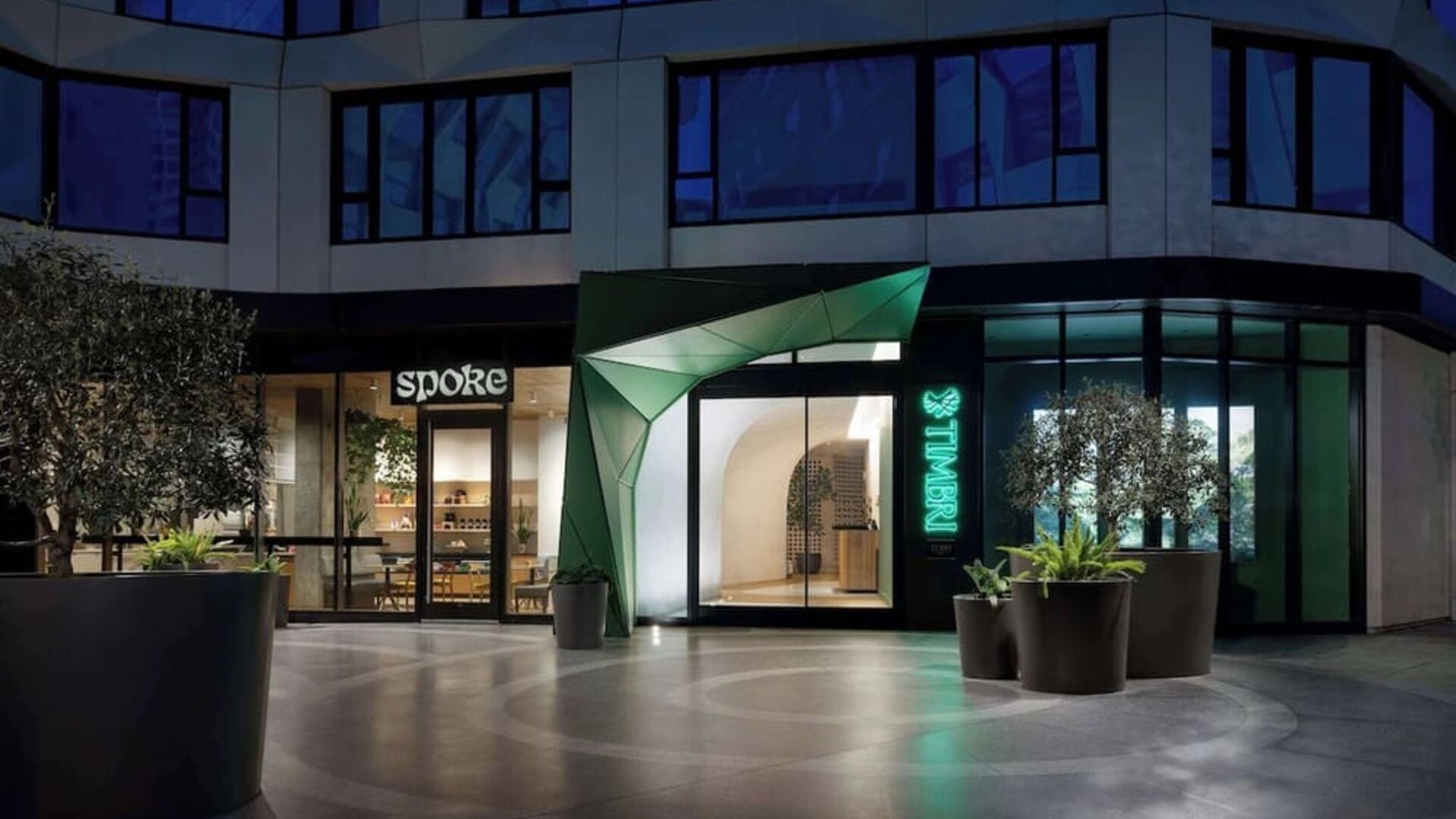 Exterior entrance of the hotel at night with illuminated signage and contemporary design at Timbri Hotel San Francisco, Curio Collection By Hilton.