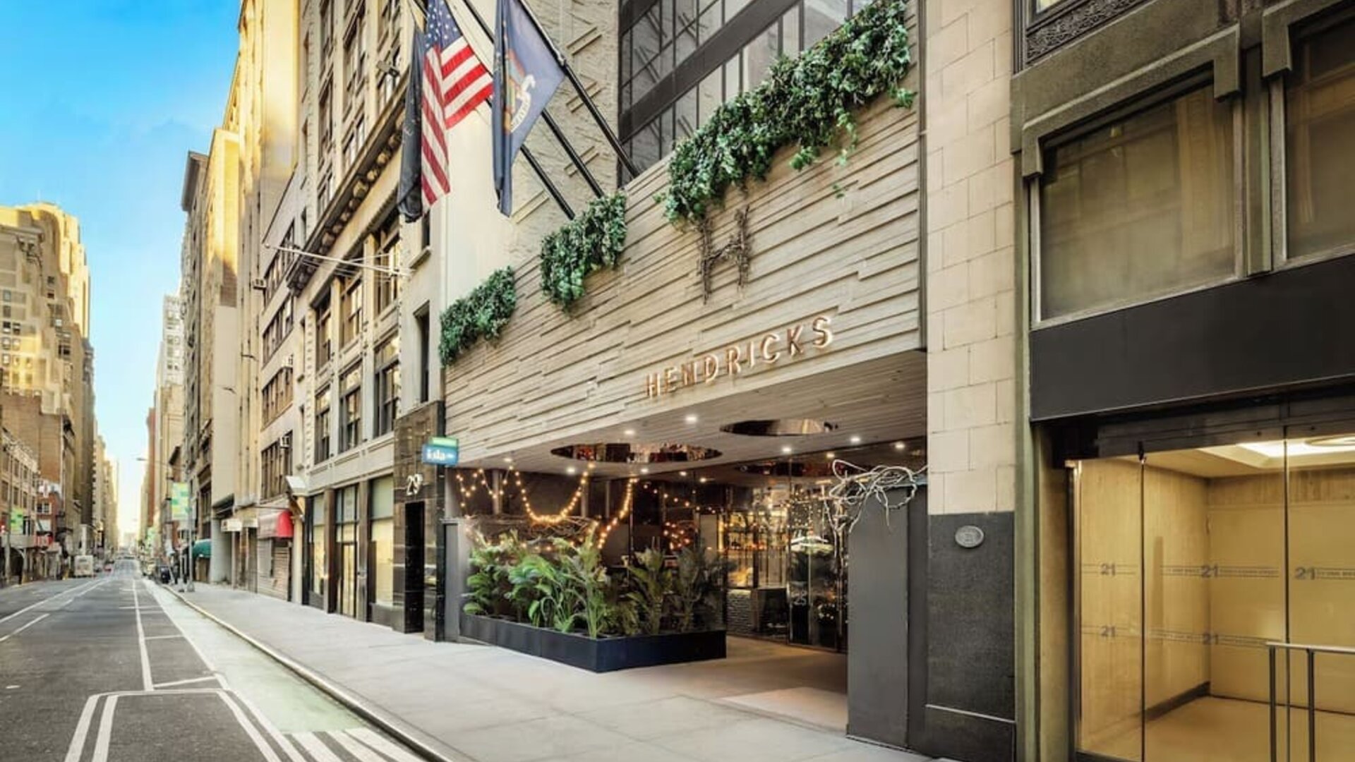 Exterior view of Hotel Hendricks with street-facing entrance and surrounding city buildings.