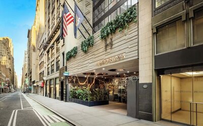 Exterior view of Hotel Hendricks with street-facing entrance and surrounding city buildings.