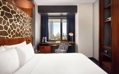 Guest room with desk setup, coffee station, and city-facing window at Hotel Hendricks.