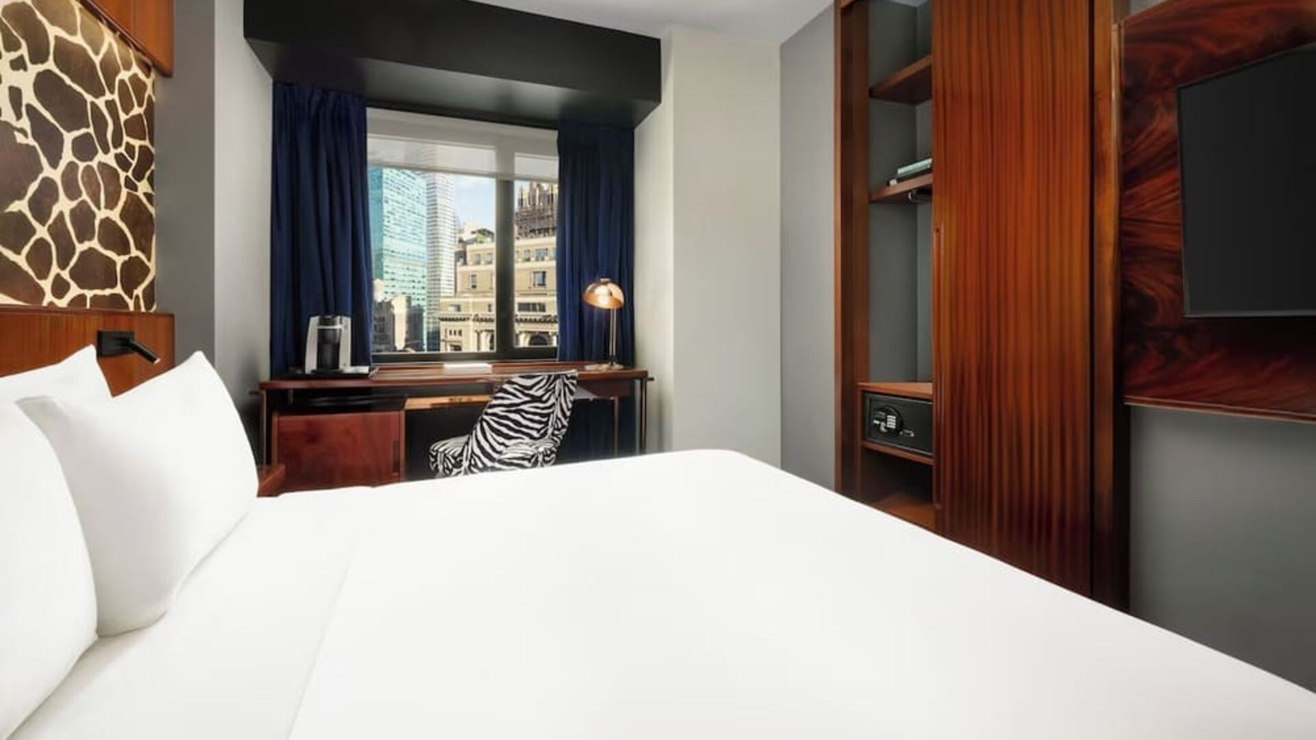 King room with modern furnishings, wardrobe space, and workspace with city views at Hotel Hendricks.