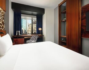 King room with modern furnishings, wardrobe space, and workspace with city views at Hotel Hendricks.