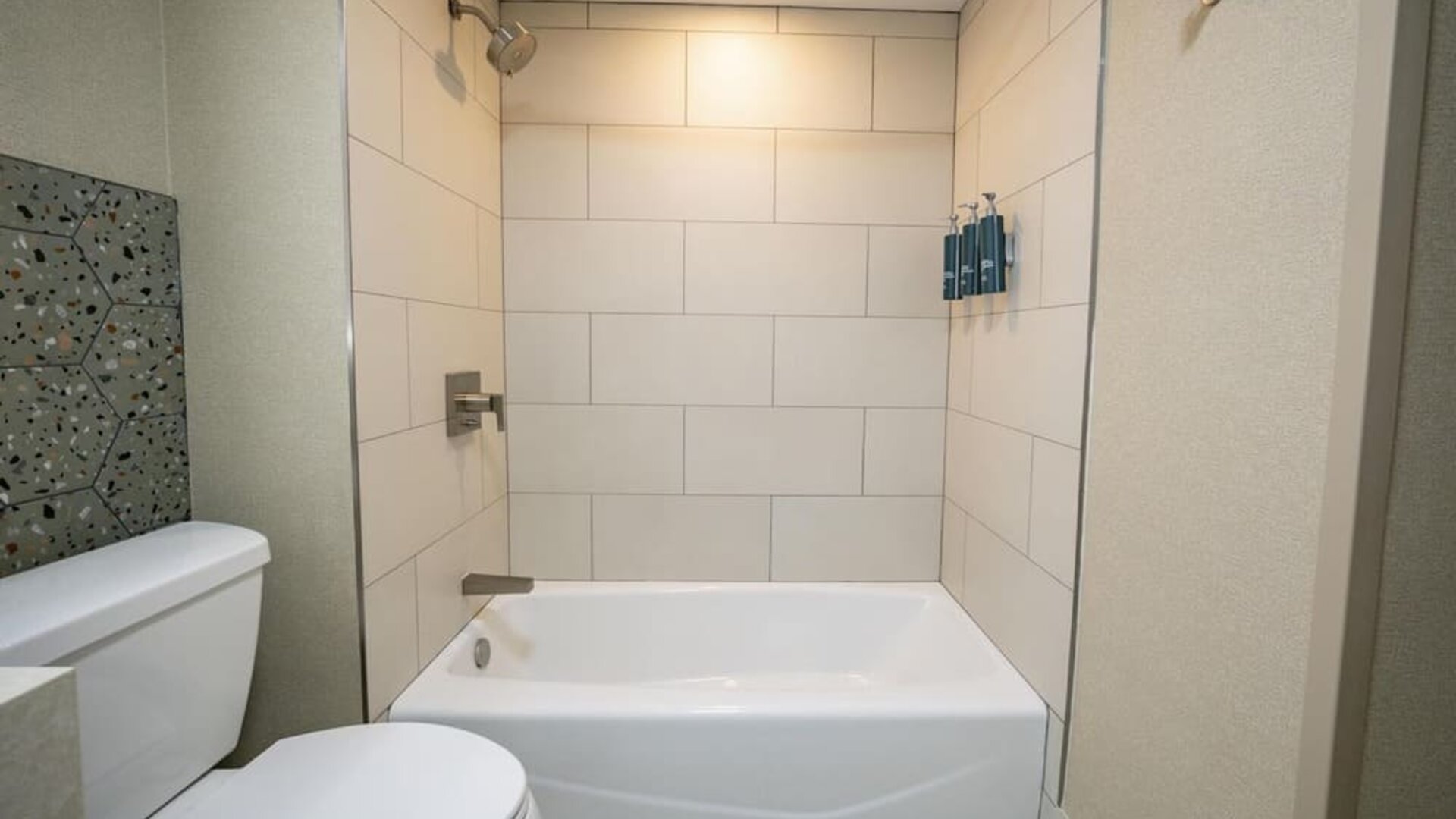 Guest bathroom with bath and shower at DoubleTree By Hilton Wilkes-Barre.