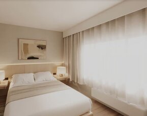 King bed with big window and natural light at DoubleTree By Hilton Wilkes-Barre.