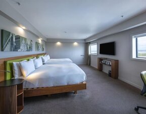 Two queen beds with TV and work desk at Hampton By Hilton Liverpool/John Lennon Airport.