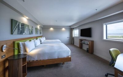 Two queen beds with TV and work desk at Hampton By Hilton Liverpool/John Lennon Airport.