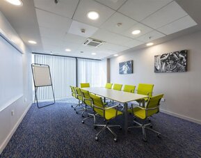 Meeting room with yellow chairs at Hampton By Hilton Liverpool/John Lennon Airport.