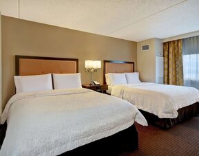 Two queen beds with natural light at Hampton Inn NY-JFK.