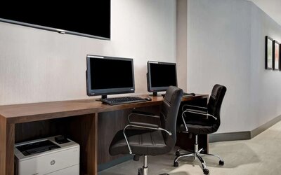 Business center with computers and printer at Hampton Inn NY-JFK.