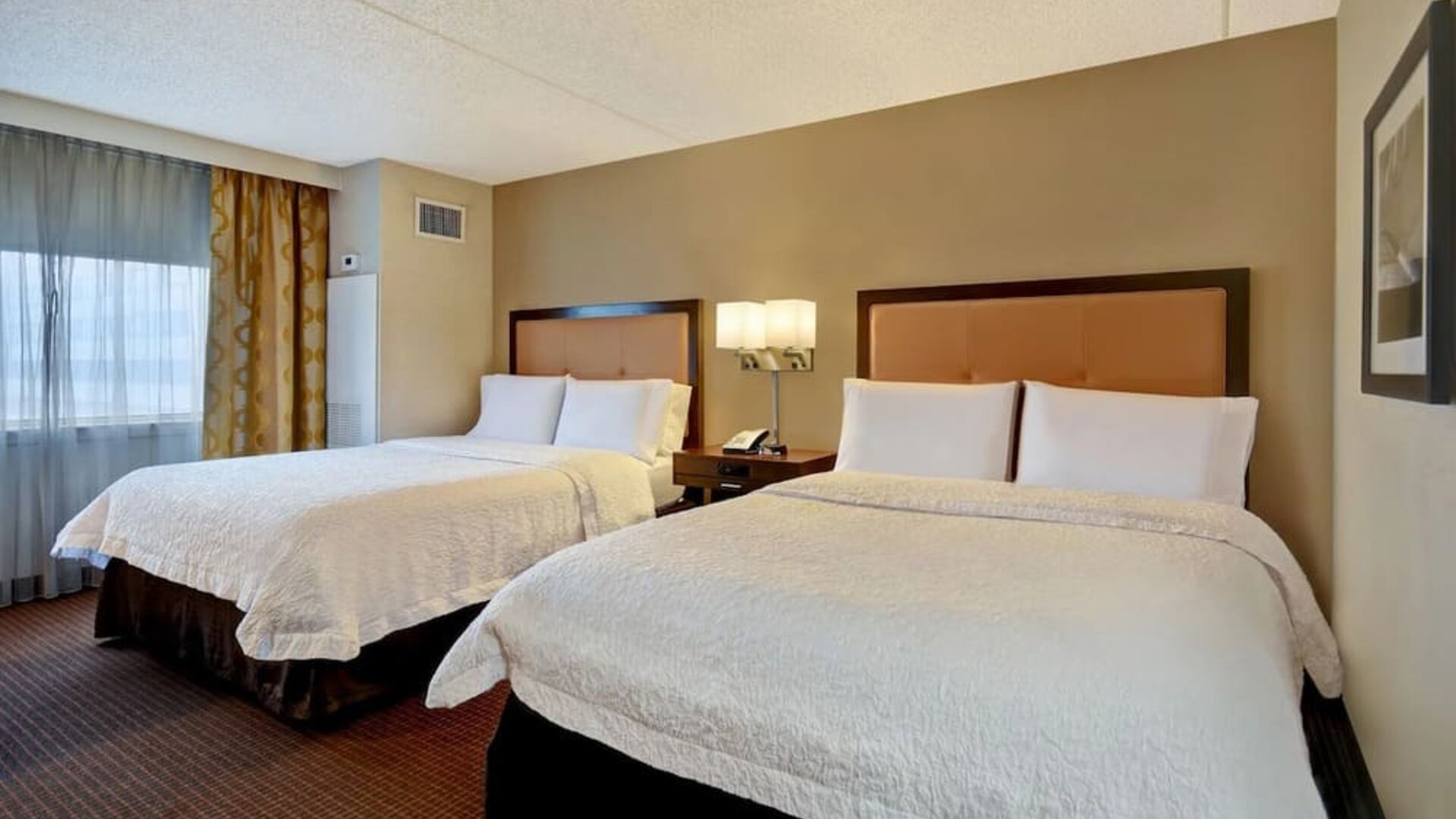 Day use room with two beds and natural light at Hampton Inn NY-JFK.