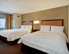 Day use room with two beds and natural light at Hampton Inn NY-JFK.