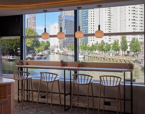 Bar seating with canal views at Haven Hotel Rotterdam.