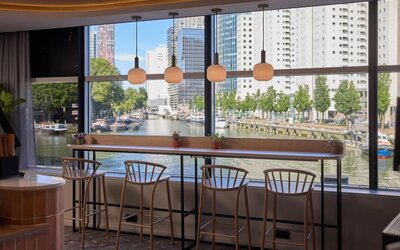 Bar seating with canal views at Haven Hotel Rotterdam.