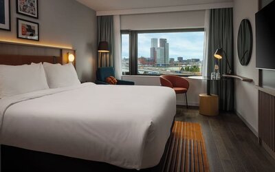 Day use room with king bed and TV at DoubleTree By Hilton Rotterdam Centre.
