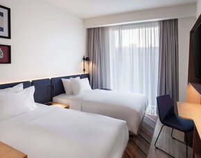 Day use room with two beds, TV, and work desk at Hampton By Hilton Tallinn.