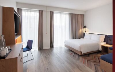 Spacious king room with TV and work desk at Hampton By Hilton Tallinn.