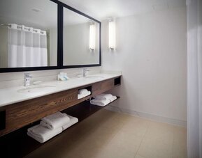 Guest bathroom with shower at Hilton Garden Inn Montreal Airport.
