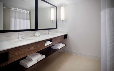 Guest bathroom with shower at Hilton Garden Inn Montreal Airport.