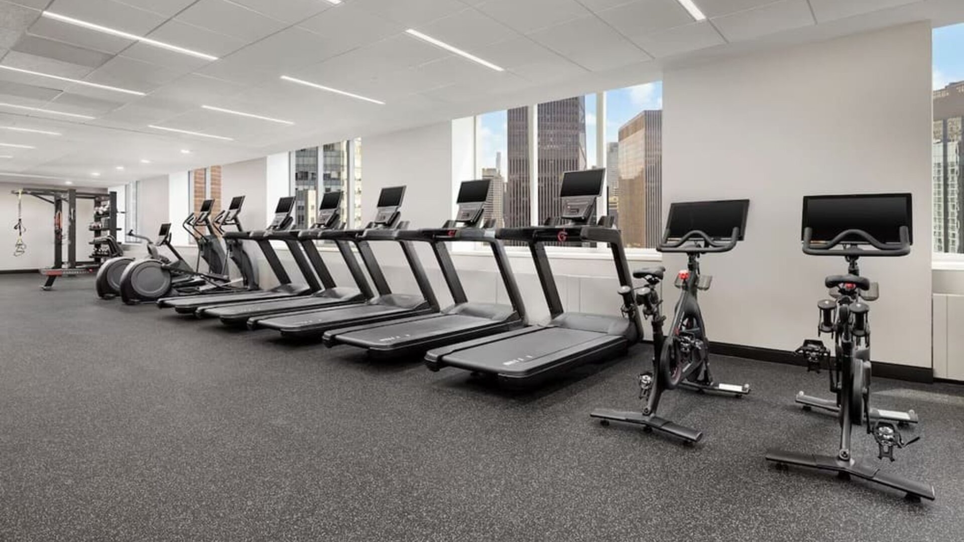 Fitness center with treadmills, bikes, and floor-to-ceiling windows at Hyatt Regency Times Square.