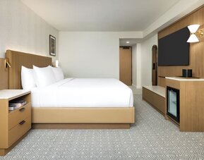 Spacious guest room with king bed, TV, and minimalist design at Hyatt Regency Times Square