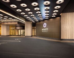 Hotel entrance with covered drop-off area and Hyatt Regency signage at Hyatt Regency Times Square.