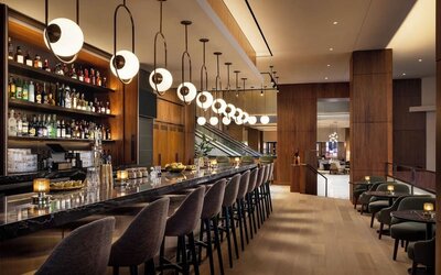 Bar area with seating, pendant lighting, and full-service counter at Hyatt Regency Times Square.