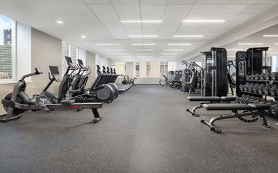 Large gym with cardio machines, weights, and strength equipment at Hyatt Regency Times Square.