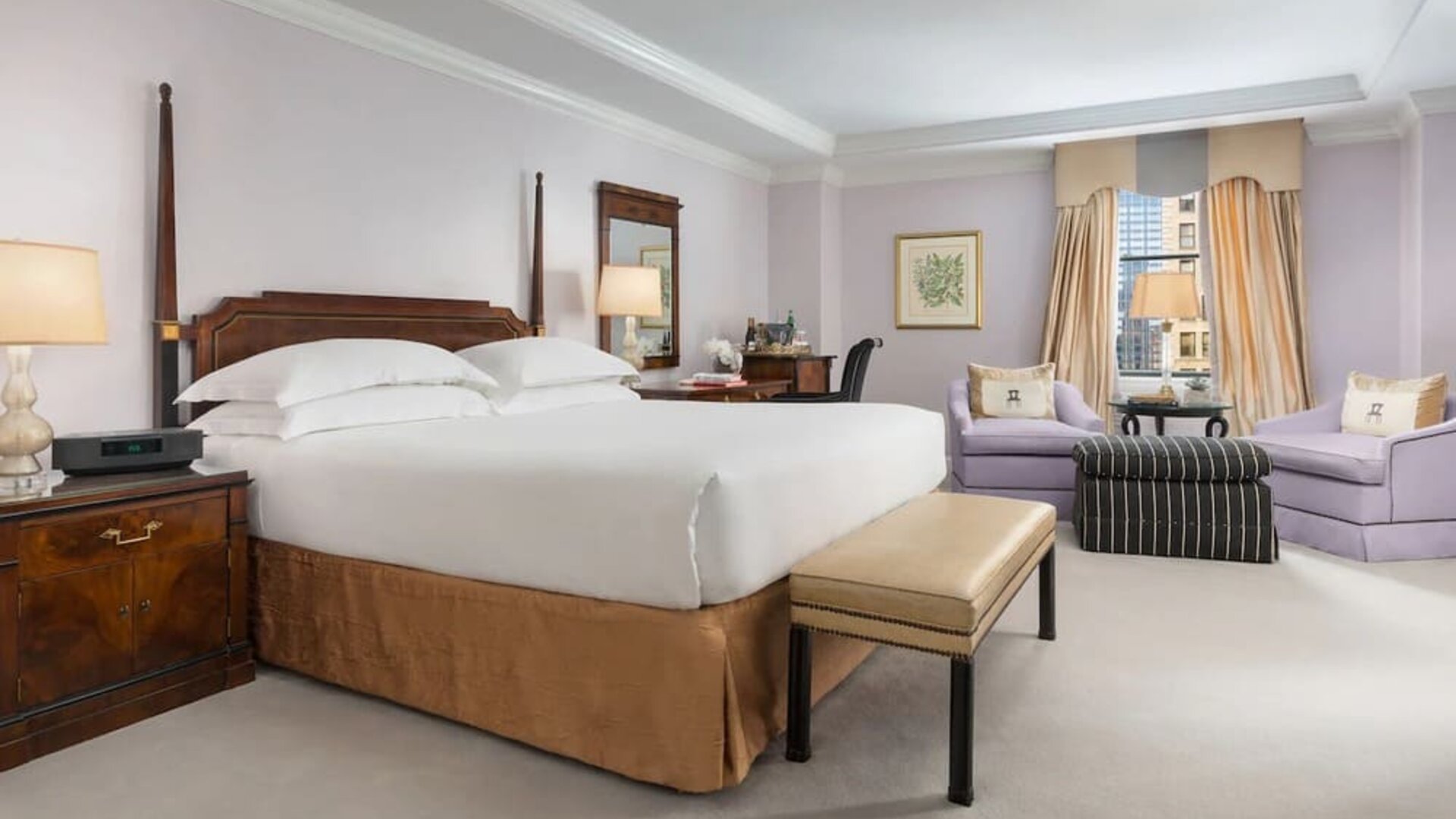 Bedroom with natural light, plush bedding, and comfortable seating at The Michelangelo New York.