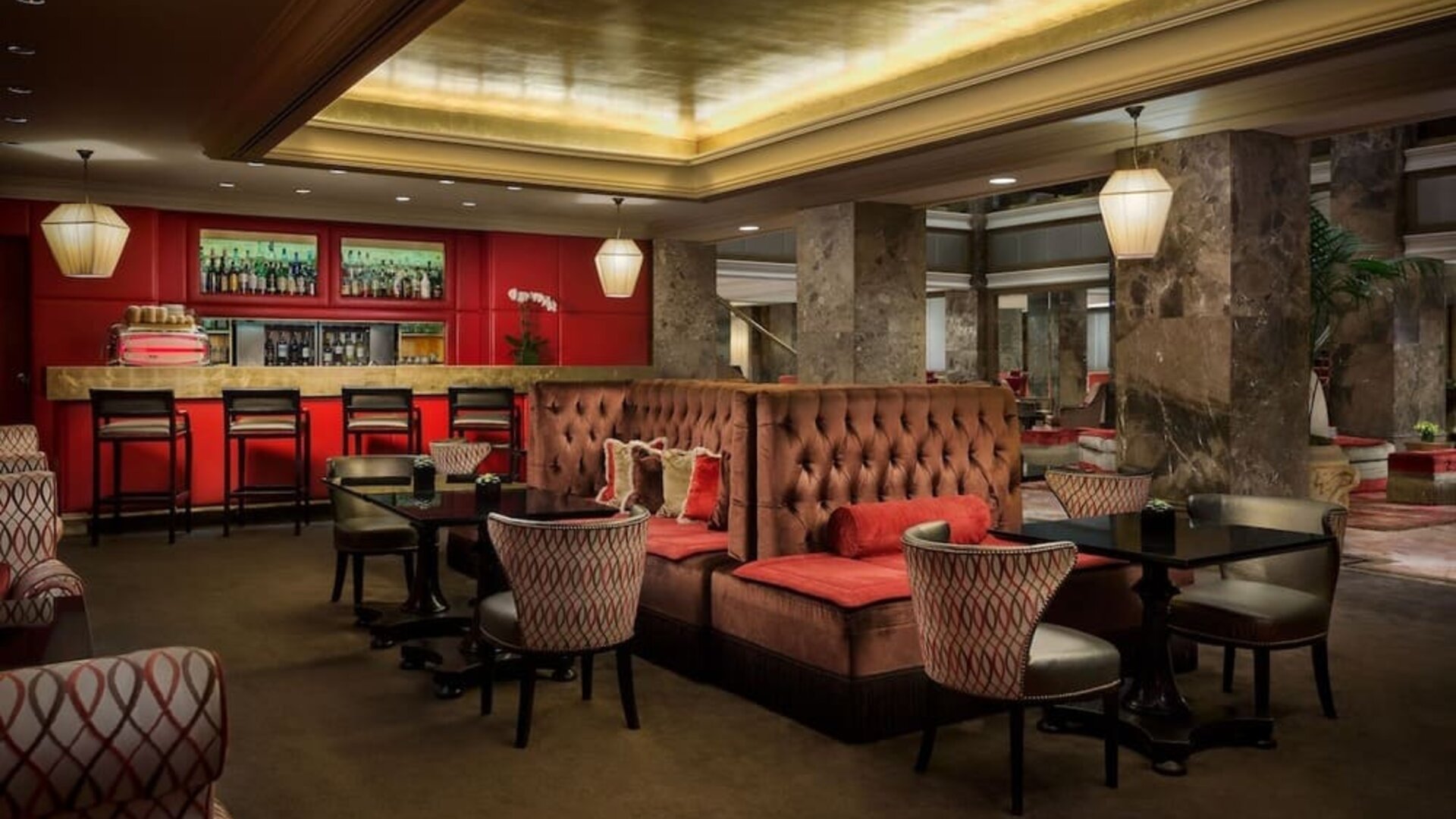 Intimate lounge and bar area with warm lighting, tufted seating, and upscale ambiance at The Michelangelo New York.