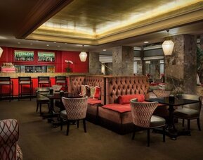 Intimate lounge and bar area with warm lighting, tufted seating, and upscale ambiance at The Michelangelo New York.