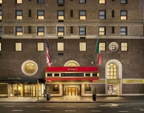 Exterior entrance with signature red awning and classic New York architecture at The Michelangelo New York.