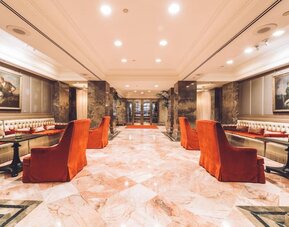 Elegant lobby seating area with classic decor and soft lighting at The Michelangelo New York.