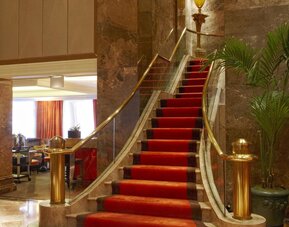 Lobby area with marble accents, upscale seating, and refined interior design at The Michelangelo New York.